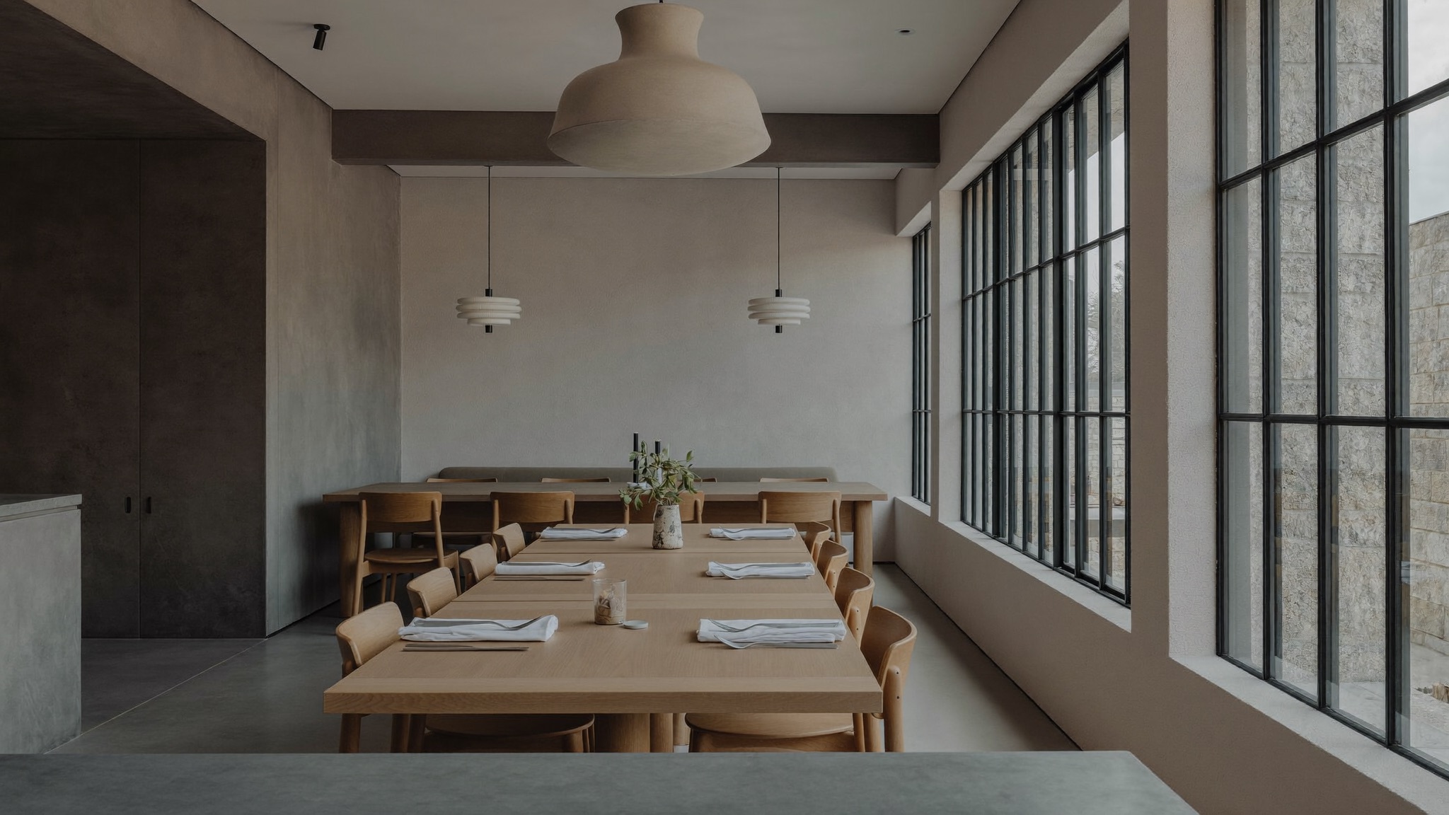 Modern, design-forward restaurant interior in cool daylight